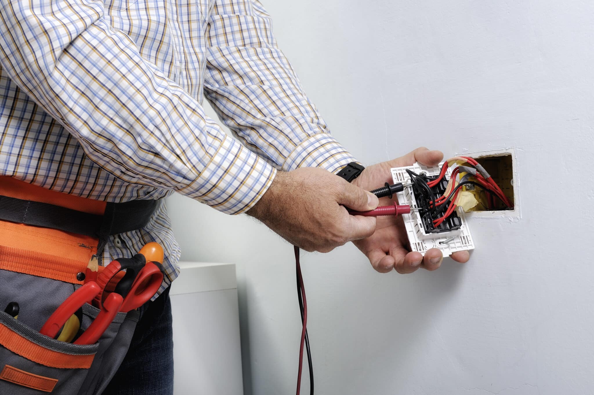 Professional electrician working on a residential electrical system.